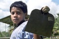 Portrait Latino, Indian, boy with hoe on shoulder Royalty Free Stock Photo