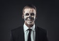 Portrait laughing businessman with makeup skeleton