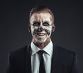 Portrait laughing businessman with makeup skeleton