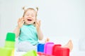 Portrait of laughing caucasian child playing with plastic toys at home Royalty Free Stock Photo