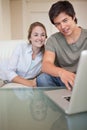 Portrait of a laughing couple using a notebook Royalty Free Stock Photo