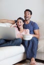 Portrait of a laughing couple watching a movie Royalty Free Stock Photo