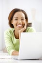 Portrait of laughing ethnic girl with laptop Royalty Free Stock Photo