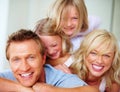 Portrait, laughing and a family lying on a bed together while in their home on a weekend morning. Face, funny and a Royalty Free Stock Photo