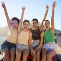 Portrait Of Laughing Female Friends Sitting On Hood Of Open Top Car On Road Trip Royalty Free Stock Photo