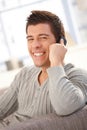 Portrait of laughing guy speaking on cellphone