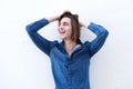 Portrait of laughing handsome man with hands in long hair