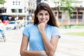 Portrait of laughing hispanic young adult woman outdoor in the city Royalty Free Stock Photo