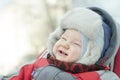 Portrait of a laughing little boy in a fur hat with a fur hat for a winter walk Royalty Free Stock Photo