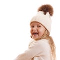 Portrait of a laughing little girl in a knitted hat with a pompon, scarf and sweater. Isolated on white background Royalty Free Stock Photo