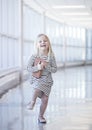 Portrait of laughing little girl wearing striped dress dancing Royalty Free Stock Photo