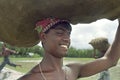 Portrait laughing man lugging burlap bag Bangladesh