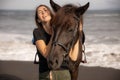 Portrait of laughing woman and brown horse. Young Caucasian woman hugging horse. Romantic concept. Love to animals. Nature concept Royalty Free Stock Photo