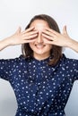 Portrait of a laughing woman closing her eyes with hands over white background. , Royalty Free Stock Photo