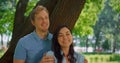 Portrait of laughing couple on sunny park. Happy pair smiling on camera closeup.