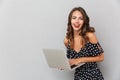 Portrait of a laughing young girl in dress over gray Royalty Free Stock Photo