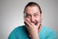 Portrait of laughing young man against grey wall. Happy guy smiling. Royalty Free Stock Photo