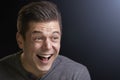 Portrait of a laughing young white man on black background Royalty Free Stock Photo