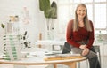 Portrait of leading businesswoman sitting on her desk. Mature businesswoman in her design agency. Creative entrepreneur