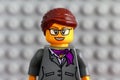 Portrait of Lego businesswoman minifigure with gray baseplate background