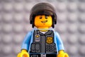 Portrait of Lego policeman minifigure against gray baseplate background