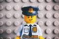 Portrait of Lego policeman minifigure with Lego gray baseplate background