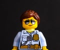 Portrait of Lego policewoman minifigure on black background