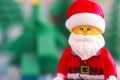 Portrait of Lego Santa Claus against Christmas trees