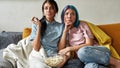 Two young girls watching boring TV show Royalty Free Stock Photo