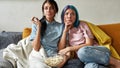 Two young girls watching boring TV show