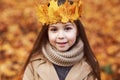 Portrait liitle cute girl with crown of leaves in autumn park