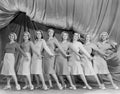 Portrait of line of female dancers on stage Royalty Free Stock Photo