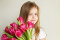 Portrait of litlle girl with bouquet of flowers tulips in her hands Royalty Free Stock Photo