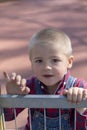 Portrait of a litte blond boy on playground