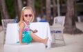 Portrait of little adorable girl on a tropical