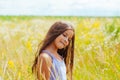 Portrait of a little adorable little girl smiling, in field with yellow flowers Royalty Free Stock Photo