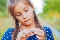 Portrait of a little adorable little girl smiling, in field with yellow flowers Royalty Free Stock Photo