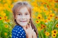 Portrait of a little adorable little girl smiling, in field with yellow flowers Royalty Free Stock Photo