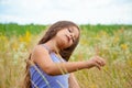 Portrait of a little adorable little girl smiling, in field with yellow flowers Royalty Free Stock Photo