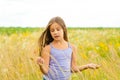 Portrait of a little adorable little girl smiling, in field with yellow flowers Royalty Free Stock Photo