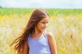 Portrait of a little adorable little girl smiling, in field with yellow flowers Royalty Free Stock Photo