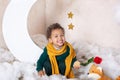 Portrait of a little African American. Baby smiles. Black boy in a green sweater and a yellow scarf smiling. Little Prince. The c Royalty Free Stock Photo