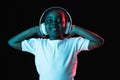 Portrait of little African-American girl isolated on dark background in neon Royalty Free Stock Photo