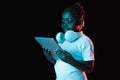 Portrait of little African-American girl isolated on dark background in neon Royalty Free Stock Photo