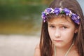 Portrait of a little anxious sad girl in a swimsuit on the beach Royalty Free Stock Photo