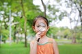 Portrait little Asian child girl looking through magnifying glass on park garden Royalty Free Stock Photo