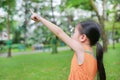 Portrait little Asian child girl looking through magnifying glass on park garden Royalty Free Stock Photo