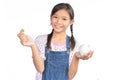 Portrait of little Asian girl holding piggy bank on white Royalty Free Stock Photo