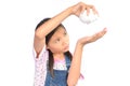 Portrait of little Asian girl holding piggy bank on white Royalty Free Stock Photo