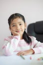 Portrait little Asian girl sitting on the chin and smile with happiness metaphor thinking someting day dreamer concept select Royalty Free Stock Photo